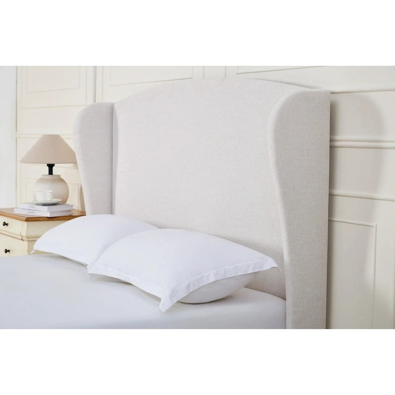 Letto a piattaforma imbottito con testiera ad ali e gambe in noce