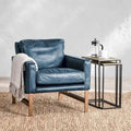 Poltrona Club in pelle blu con struttura in ottone 22W x 21D x 18.5H